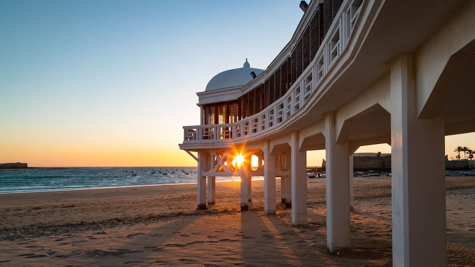 La Caleta Beach featuring a sunset, a beach and general coastal views