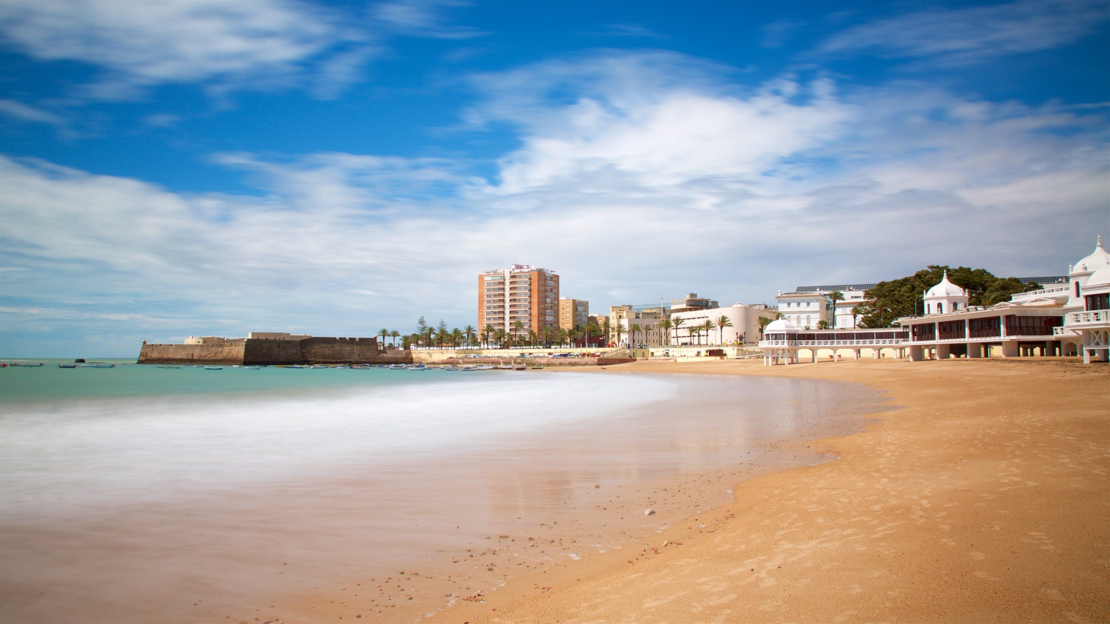 La Caleta Beach which includes a bay or harbor and a beach