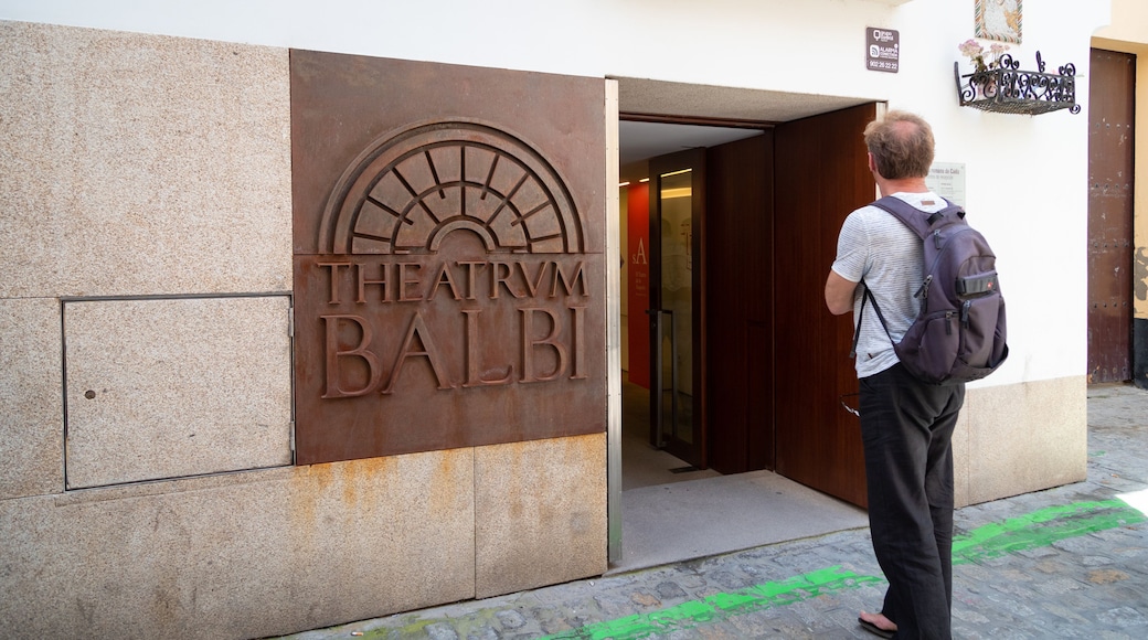 Roman Theater featuring street scenes and signage as well as an individual male