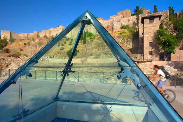Malaga Amphitheatre featuring heritage architecture and cycling as well as an individual male