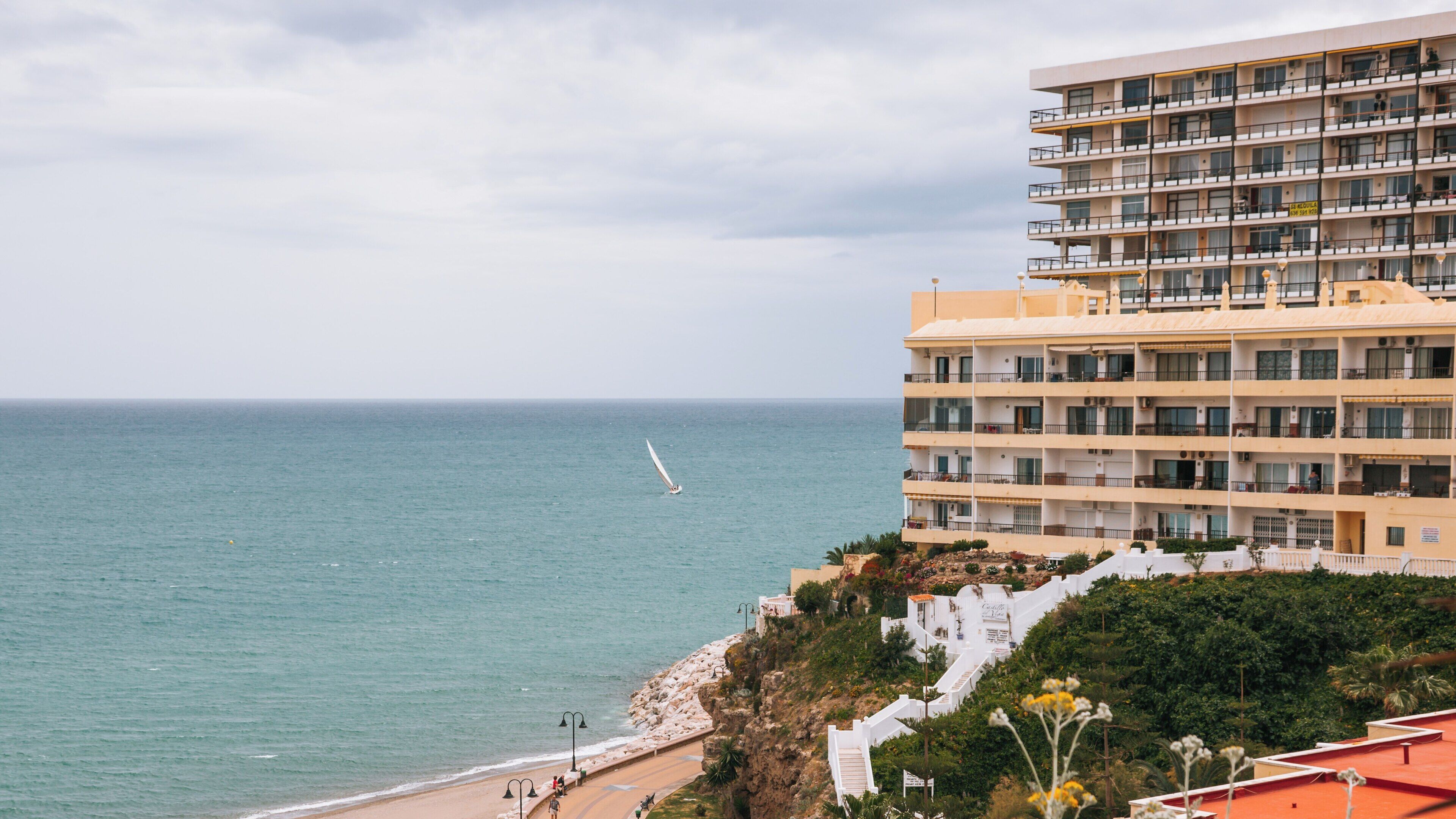 Carihuela Beach in Torremolinos Spain with coastal views and a hint of adventure sailing on a serene day by the sea