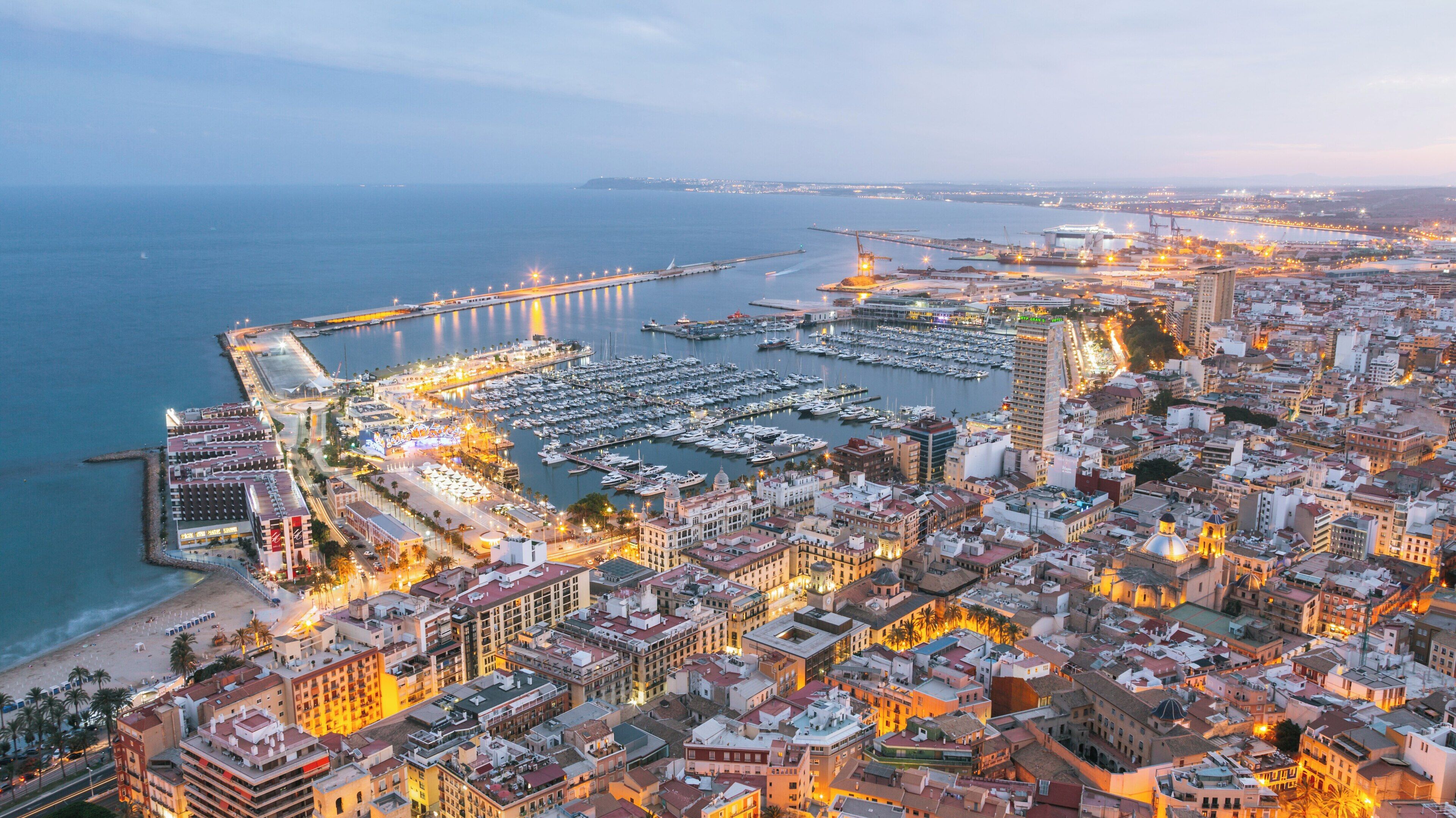 Castle of Santa Barbara overlooking the vibrant coastal city of Alicante during twilight in the Valencian Community of Spain