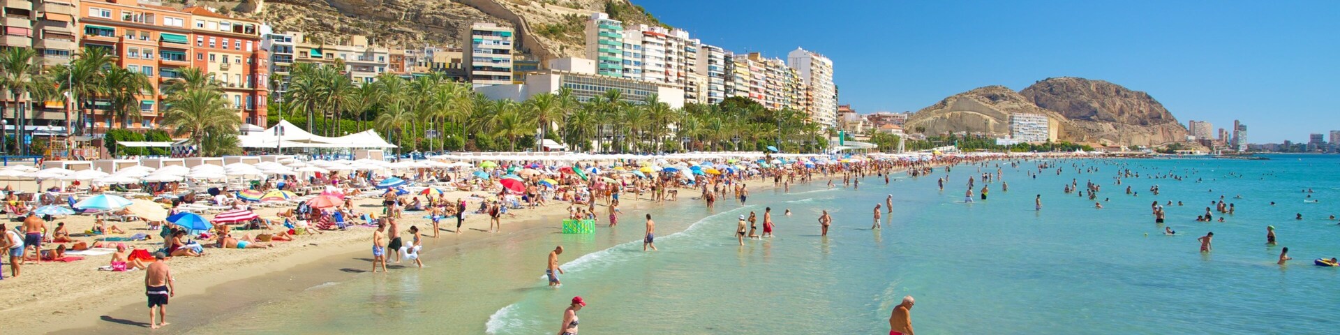 Postiguet Beach showing a coastal town, a beach and landscape views