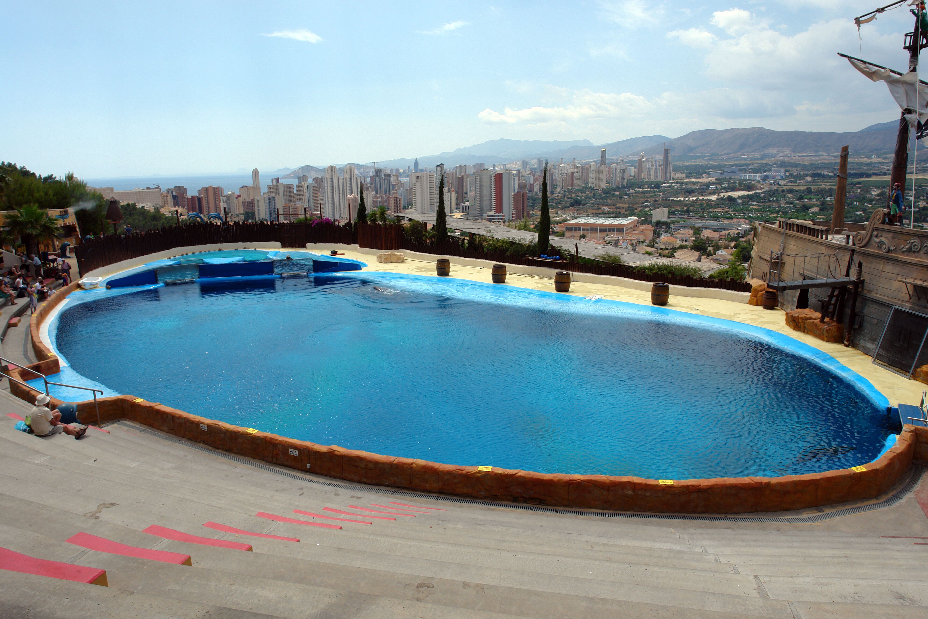 Dolphinarium Pool at Aqualandia Water Park with Benidorm City and Mediterranean Sea at Horizon