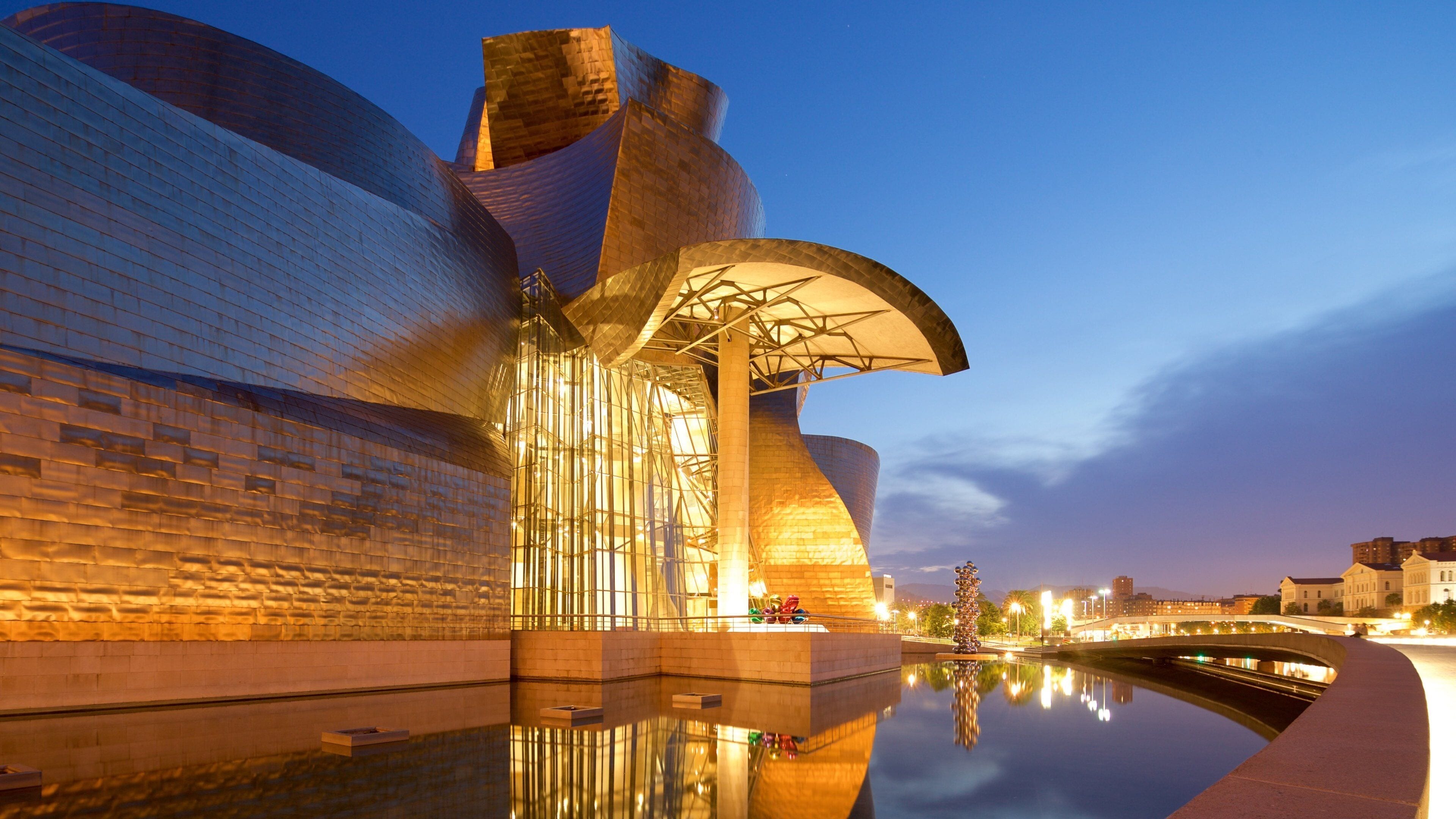 Guggenheim Museum Bilbao which includes night scenes, outdoor art and modern architecture