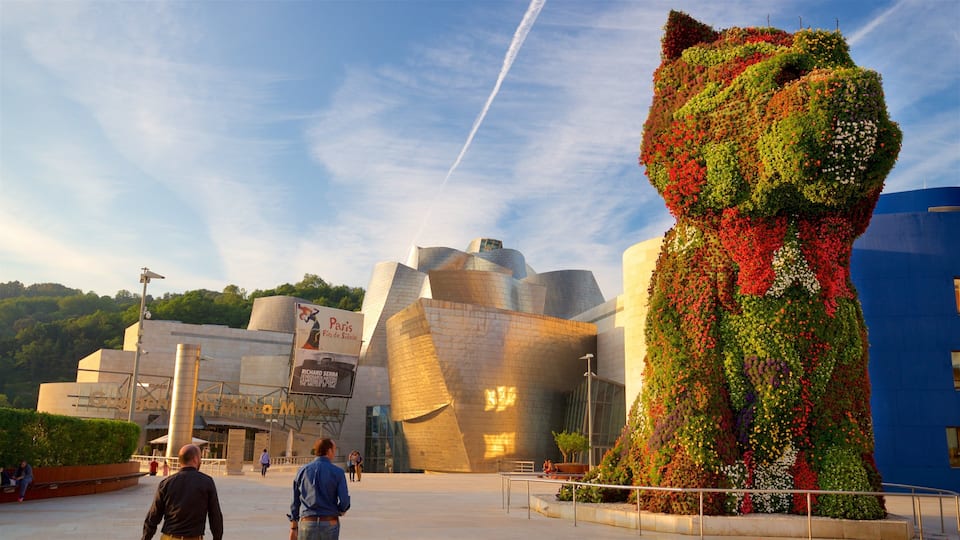 Guggenheim Museum Bilbao which includes modern architecture, outdoor art and a sunset