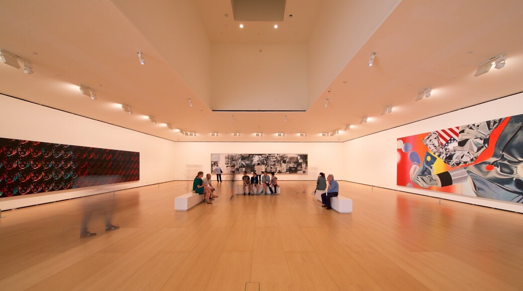 Guggenheim Museum Bilbao featuring art and interior views as well as a small group of people