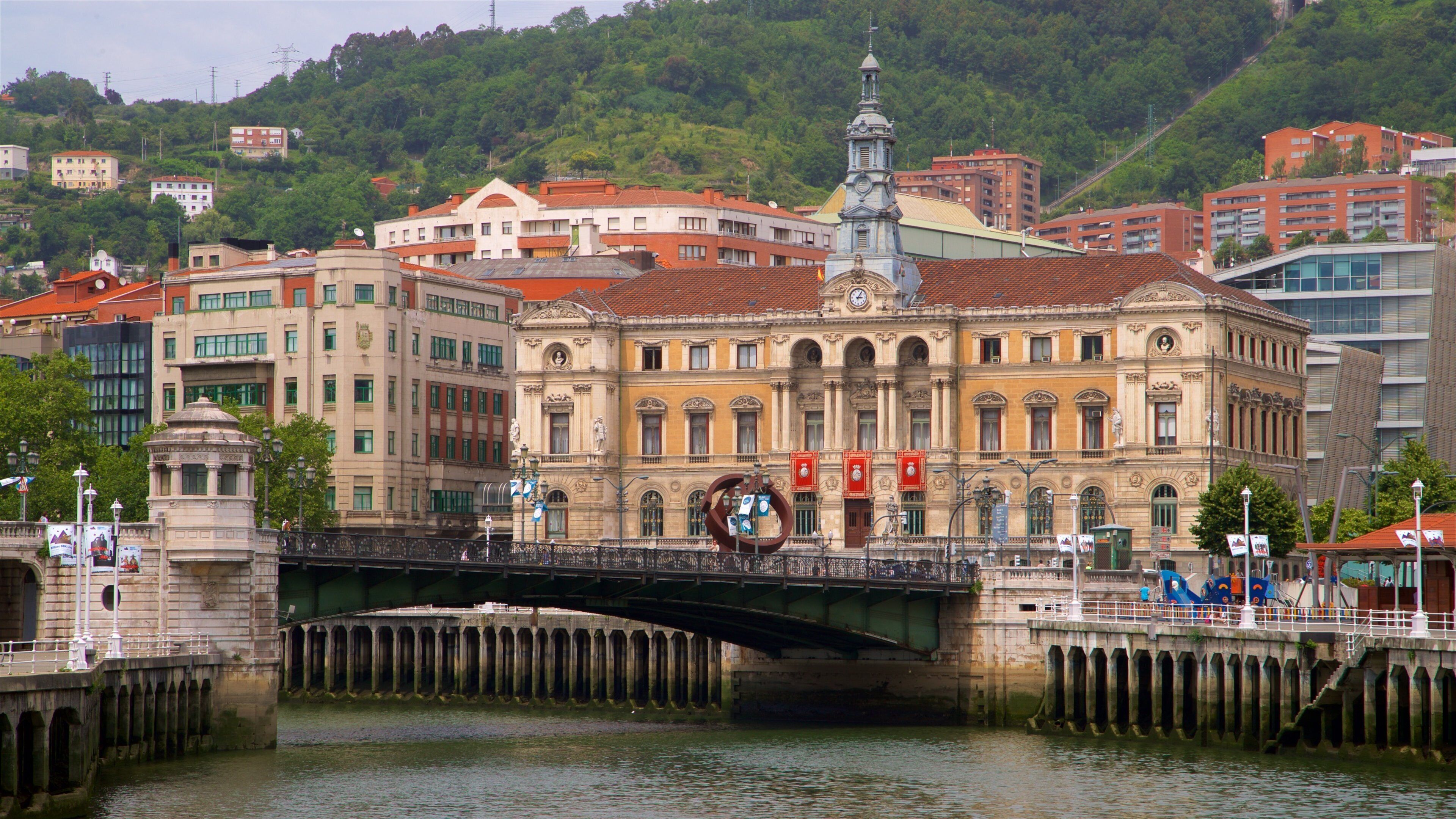 Bilbao City Hall which includes heritage architecture, a river or creek and a bridge