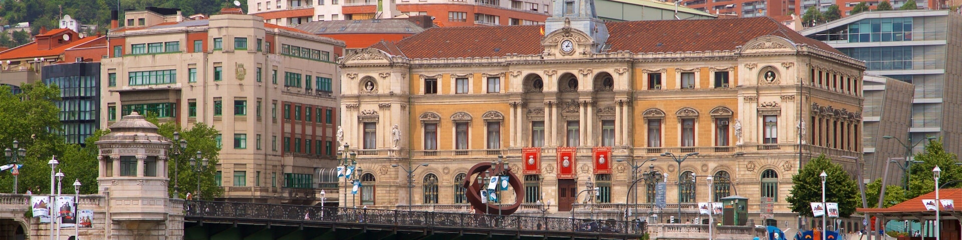 Bilbao City Hall which includes heritage architecture, a river or creek and a bridge