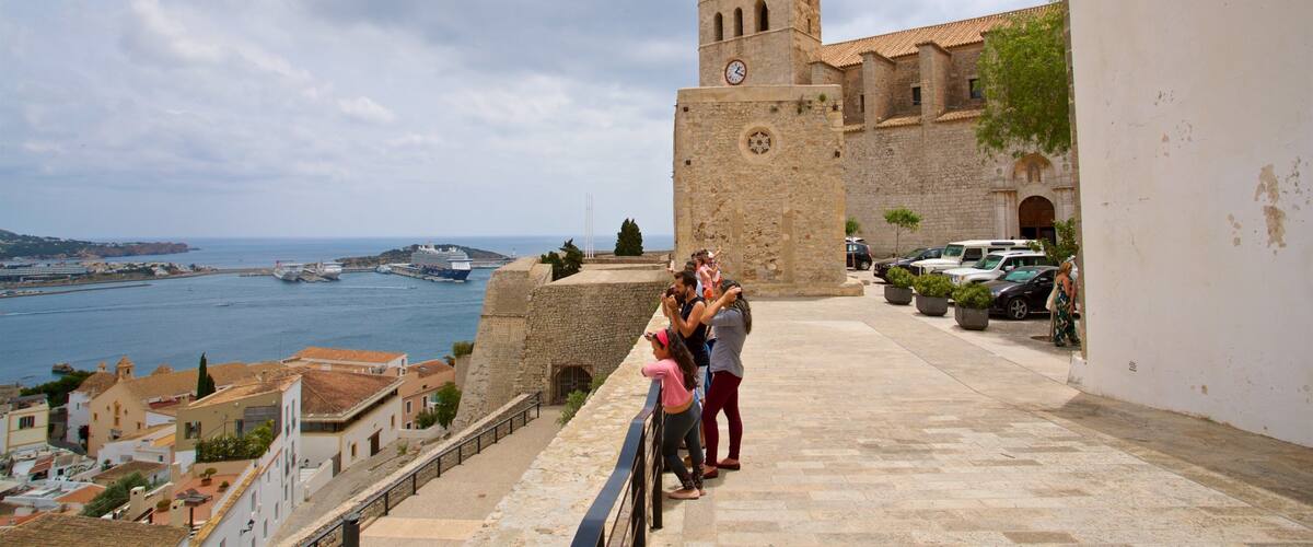 Ibiza Cathedral showing heritage elements and a bay or harbor as well as a family