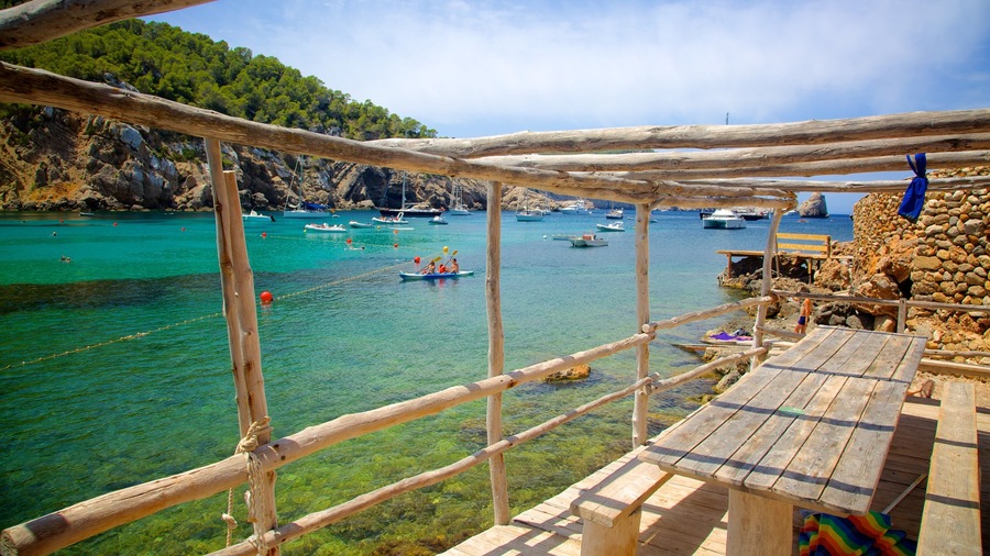 Benirras Beach featuring rocky coastline and boating