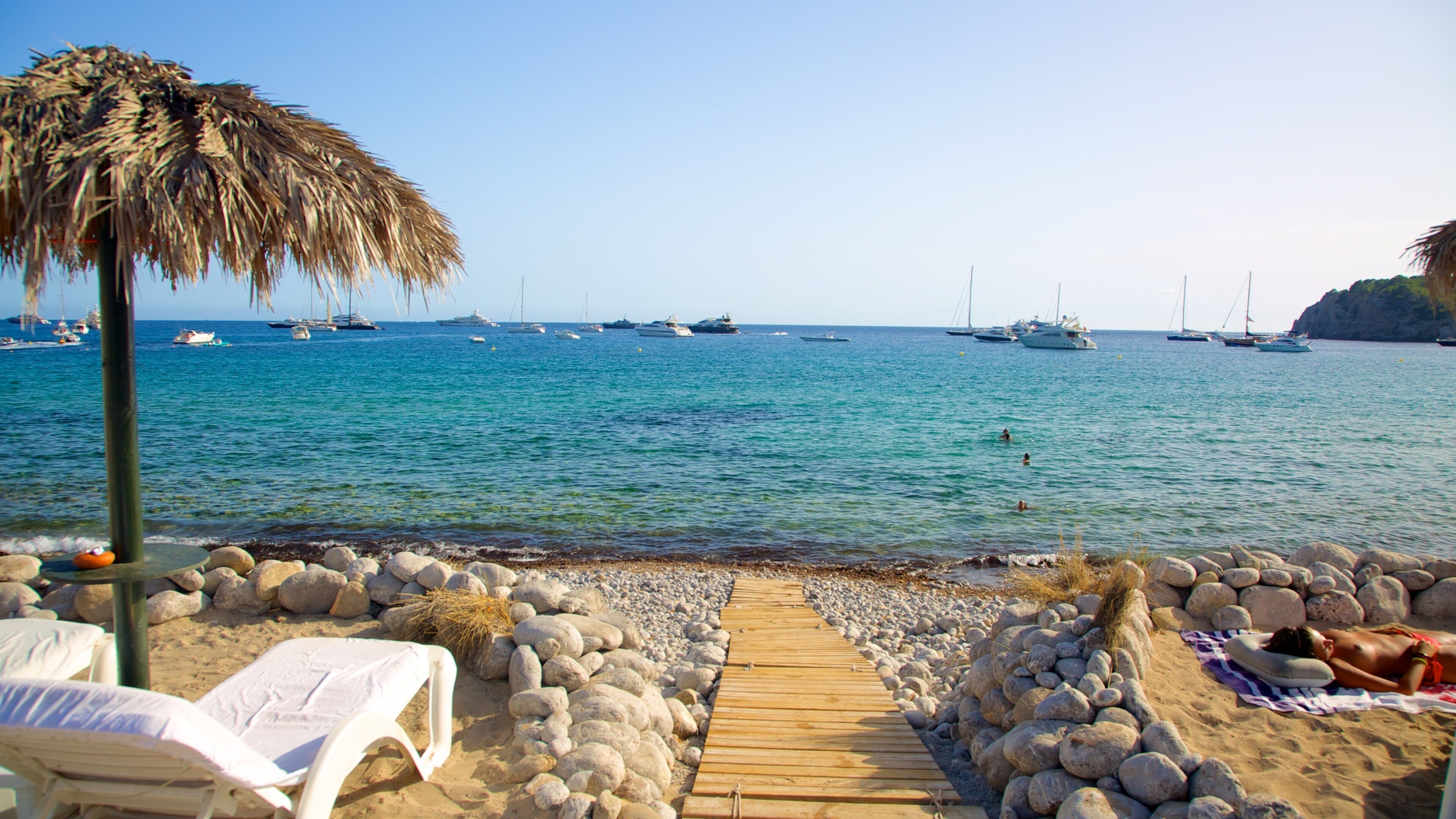 Cala Jondal Beach which includes a sandy beach, tropical scenes and boating