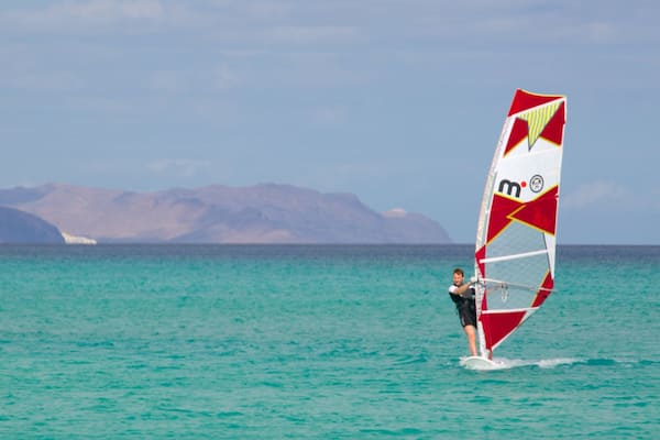 Sotavento de Jandia Beach featuring general coastal views and windsurfing as well as an individual male