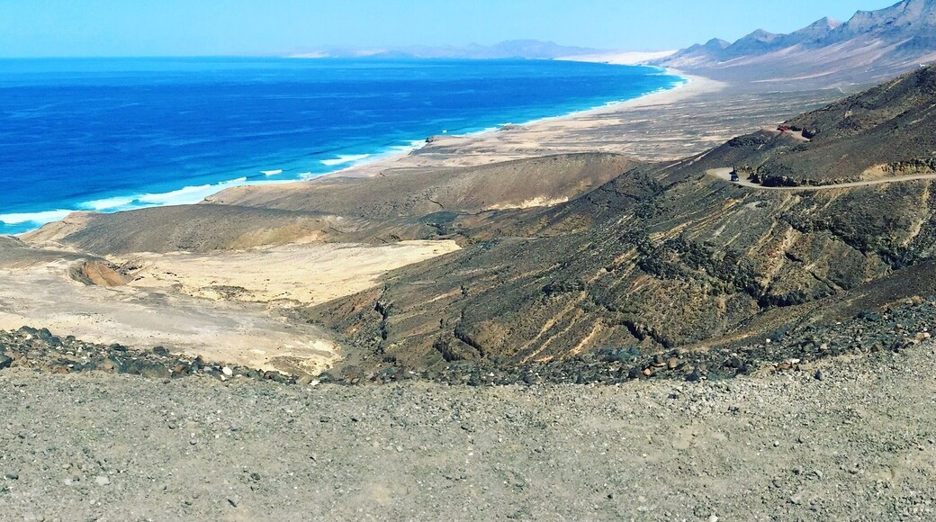 Stunning beach which is a beautiful untouched area on the south west end of Fuertaventura. A fun off road (very good condition) to get to. Climbing through the volcanos you pop out over the top and see this view. There is a little cafe to stop at at the bottom in the village you can grab a drink. I would suggest taking a packed lunch and lots of sun cream. The waves are massive so be prepared but a fun swim and body surfing session. Enjoy.