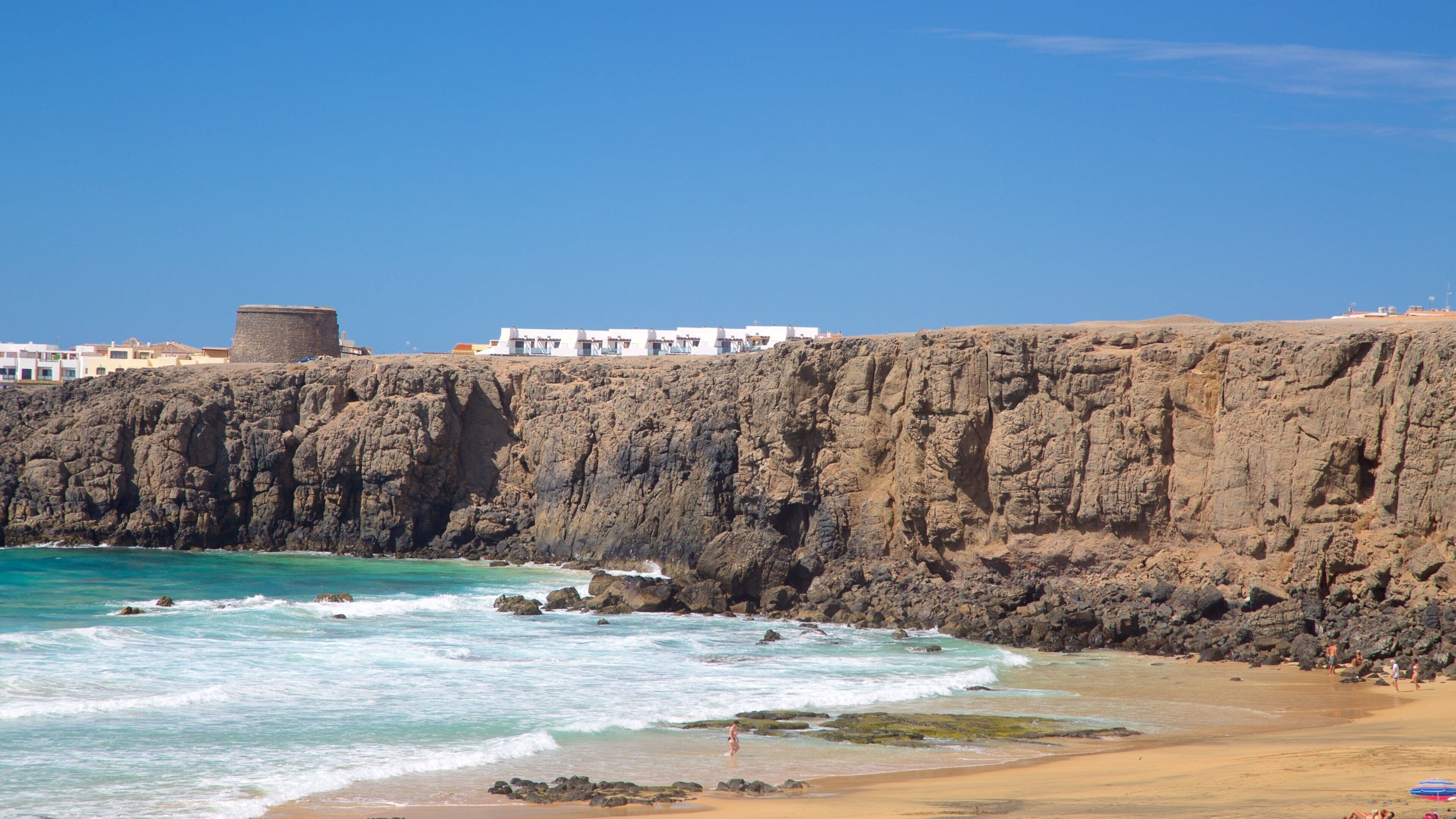 Cotillo Beach which includes rugged coastline, a sandy beach and general coastal views