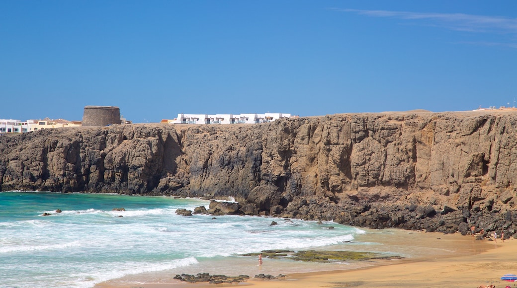 Cotillo Beach which includes rugged coastline, a sandy beach and general coastal views