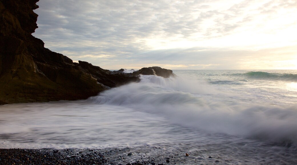 Ajuy Beach showing rugged coastline, a pebble beach and surf