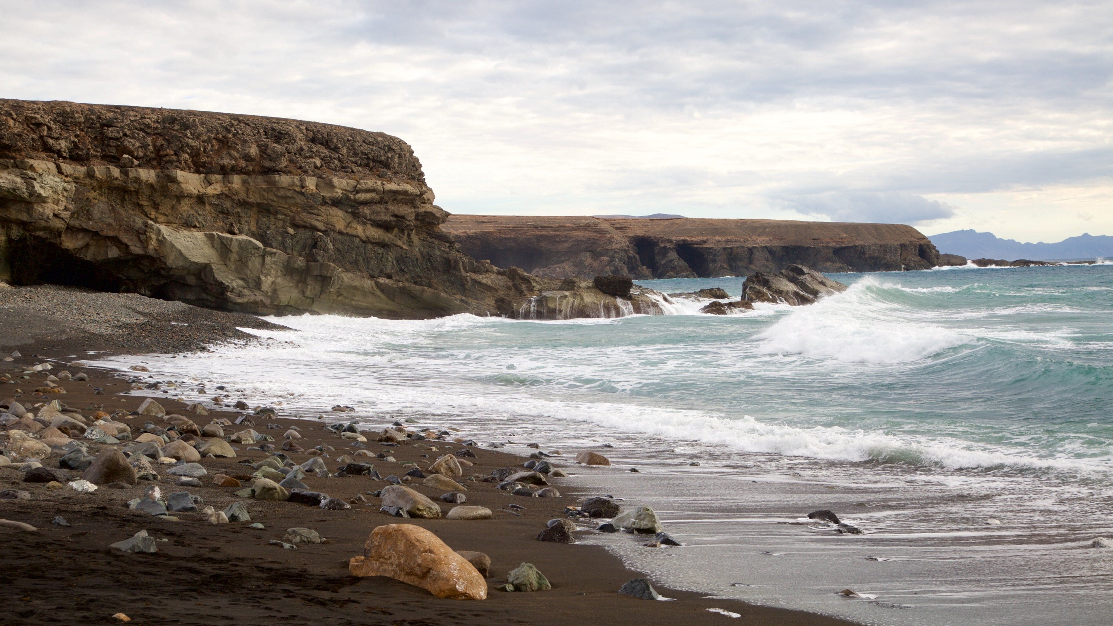 Ajuy Beach featuring rugged coastline, general coastal views and waves