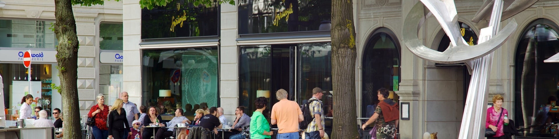 Paradeplatz showing cycling and street scenes as well as a large group of people