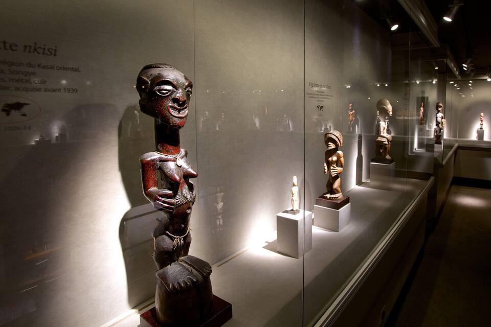 A museum exhibit with various wooden sculptures.