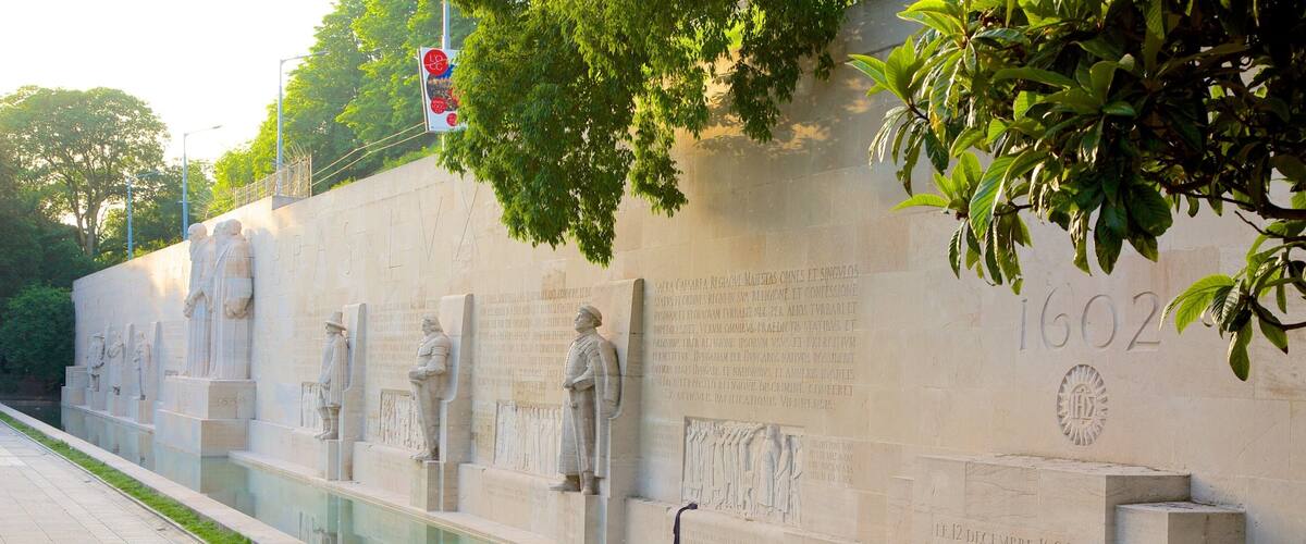Reformation Wall Monument which includes a monument, a pond and a statue or sculpture