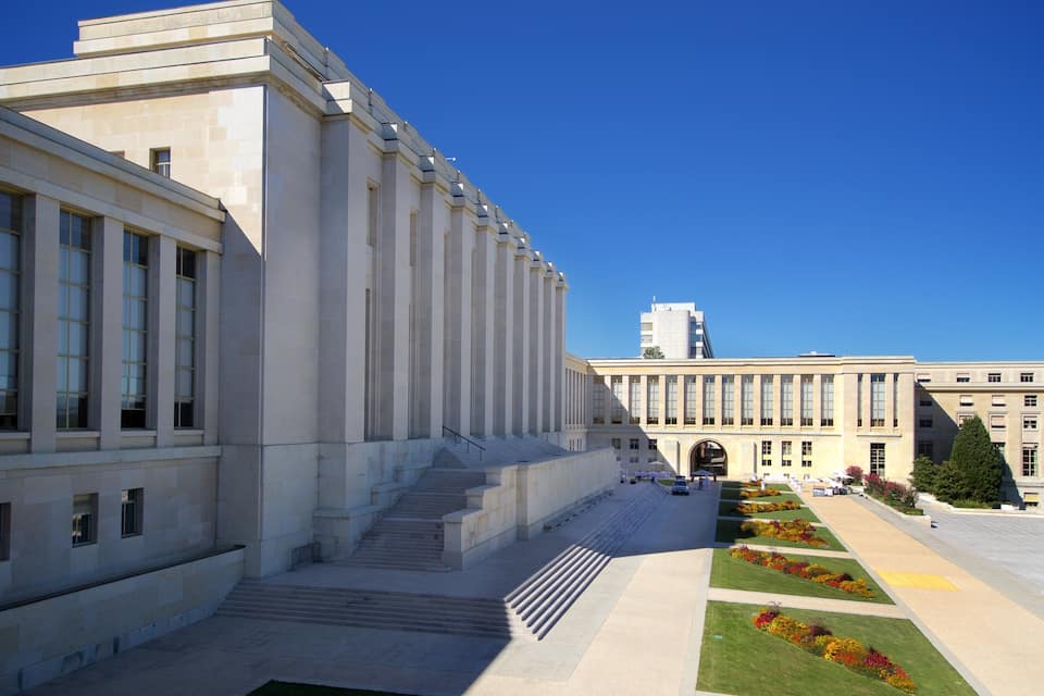 A large, modern building with a symmetrical facade and a central staircase leading to an entrance.