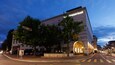 A modern building with a sign reading "museum basel" at dusk.