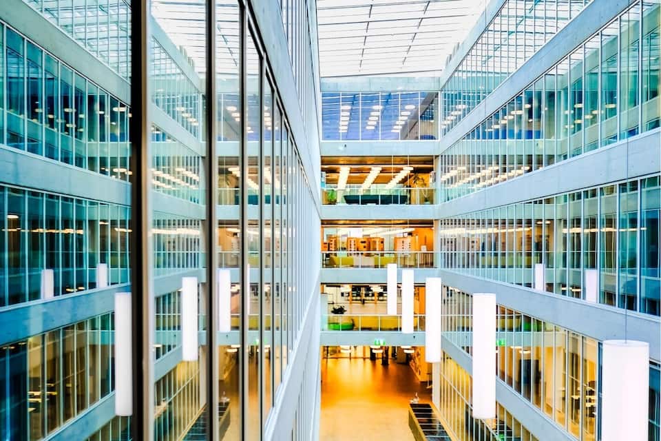 A modern building with a glass facade and a central open space.