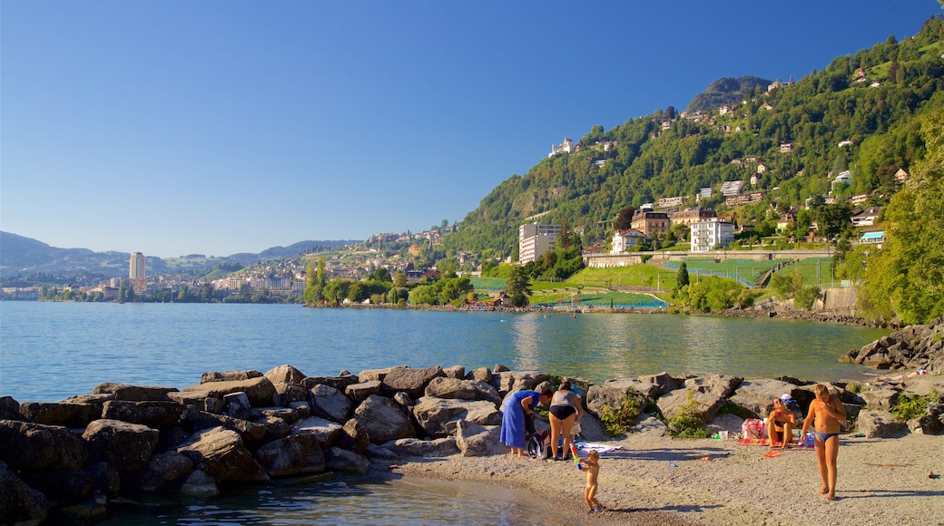 Chateau de Chillon showing a beach and a lake or waterhole as well as a family