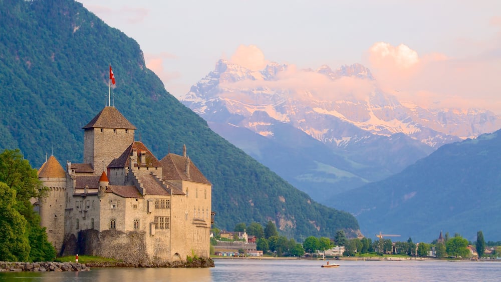 Chateau de Chillon which includes mountains, a lake or waterhole and a castle