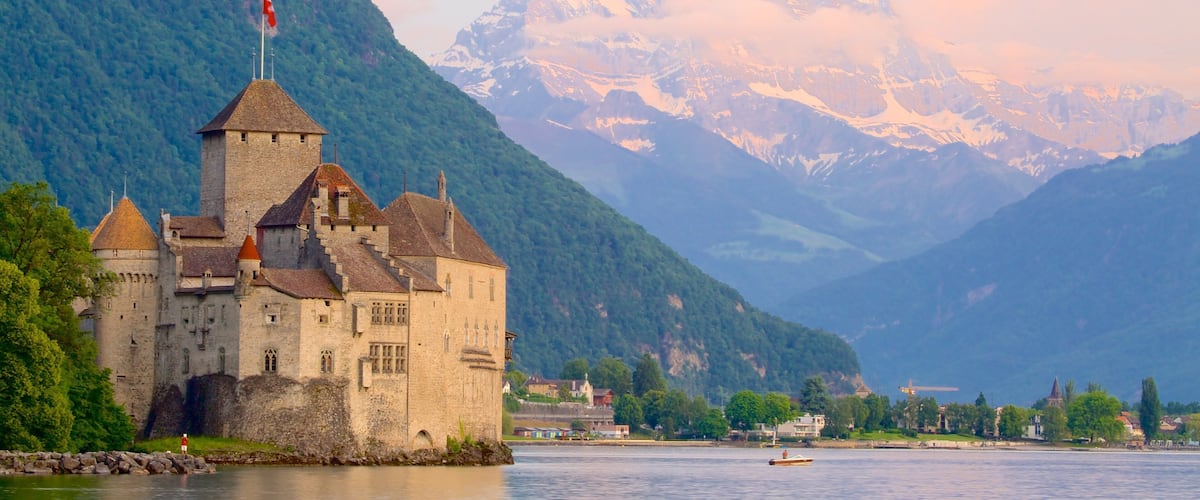Chateau de Chillon which includes a castle, a lake or waterhole and mountains
