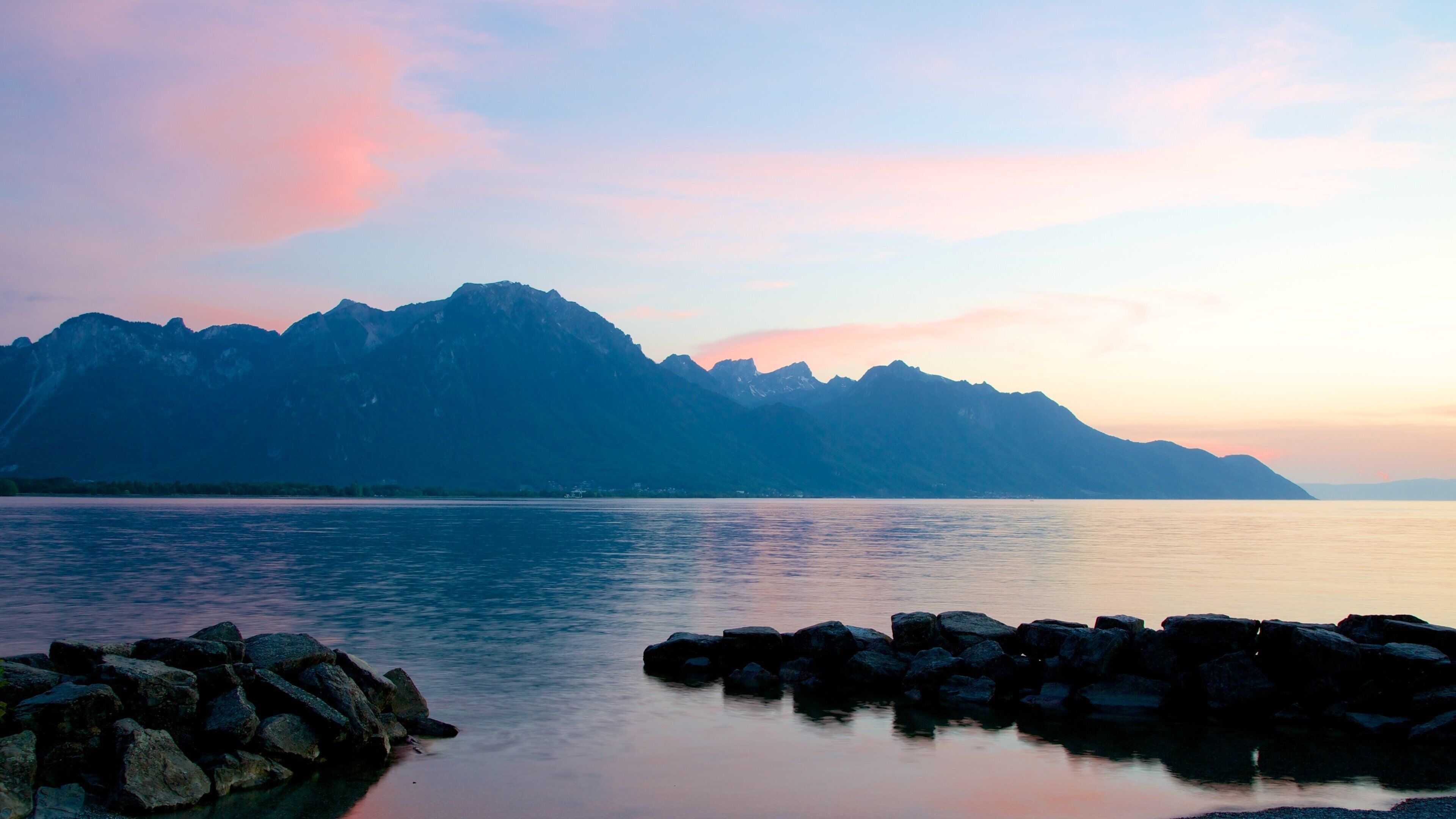 Chateau de Chillon featuring mountains, a lake or waterhole and a sunset