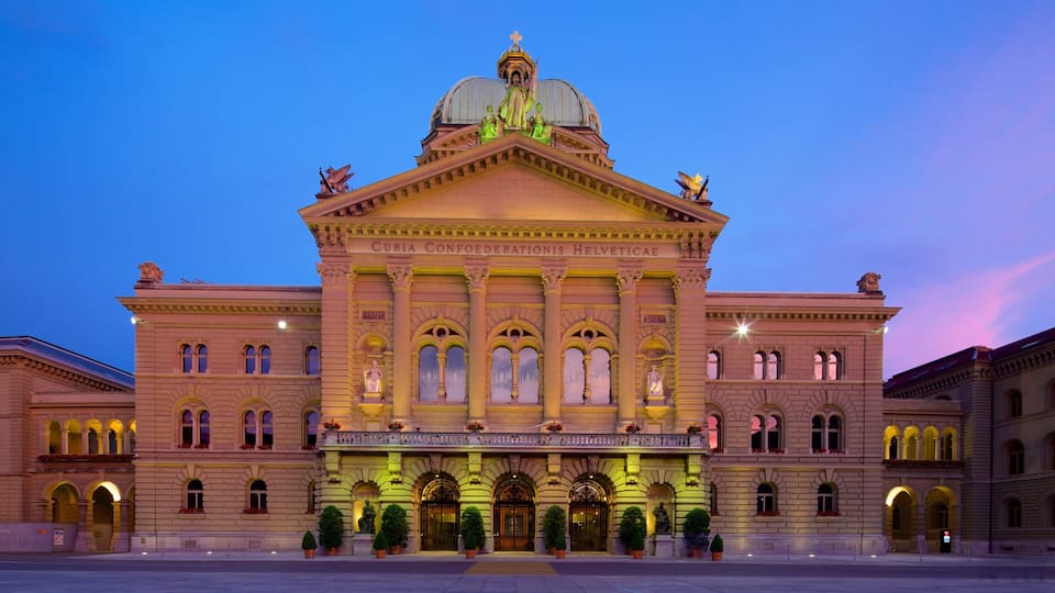 A grand building with a large dome and statues on the roof.