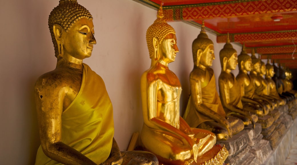 Detailed view of golden Buddha statues at Wat Pho in Bangkok highlighting Thai culture and spirituality