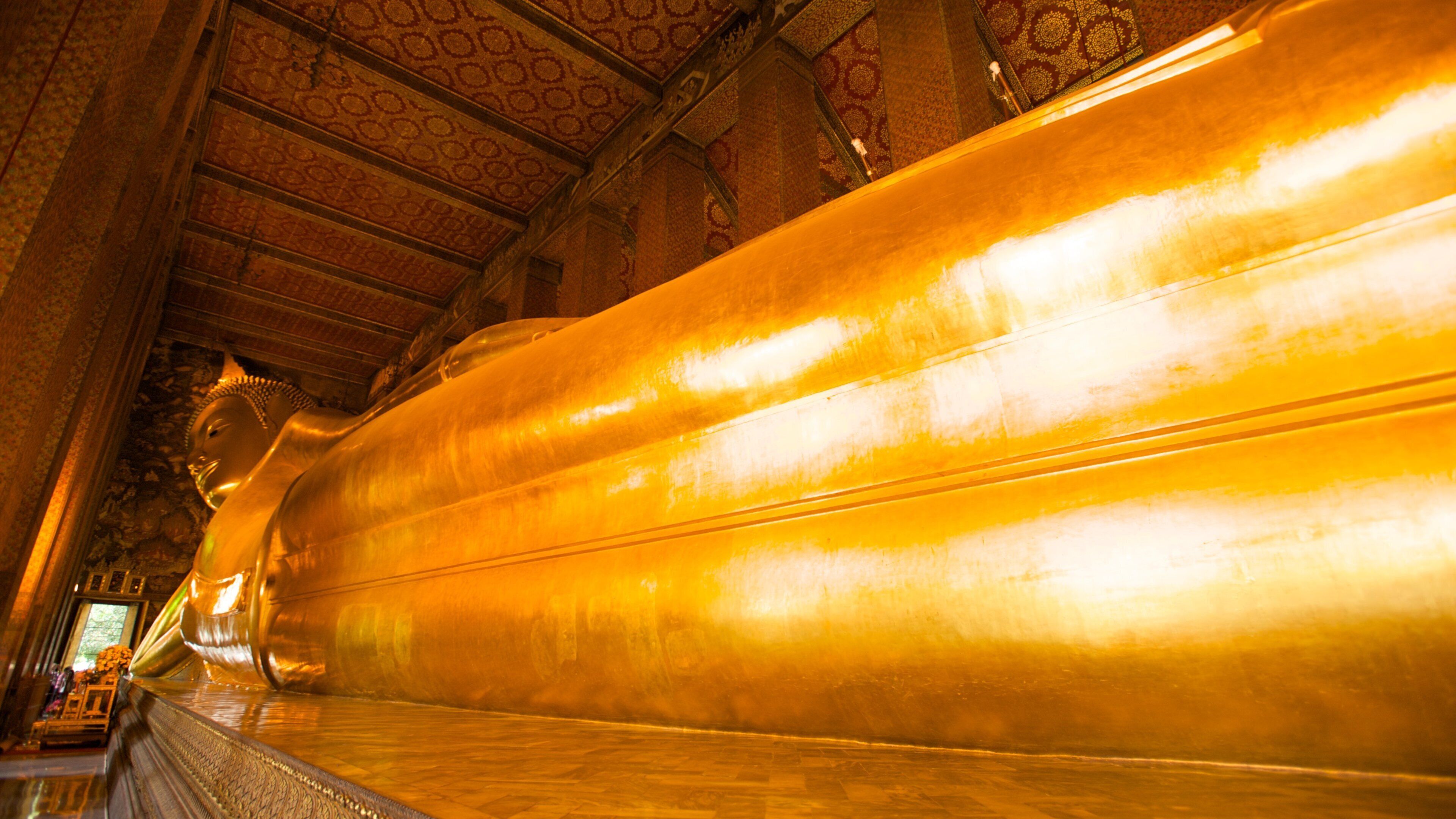 Discover Wat Pho's Reclining Buddha in Bangkok showcasing intricate details and serene atmosphere in the temple
