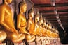 Thailand, Bangkok, Wat Suthat, Row of golden Buddha figurines