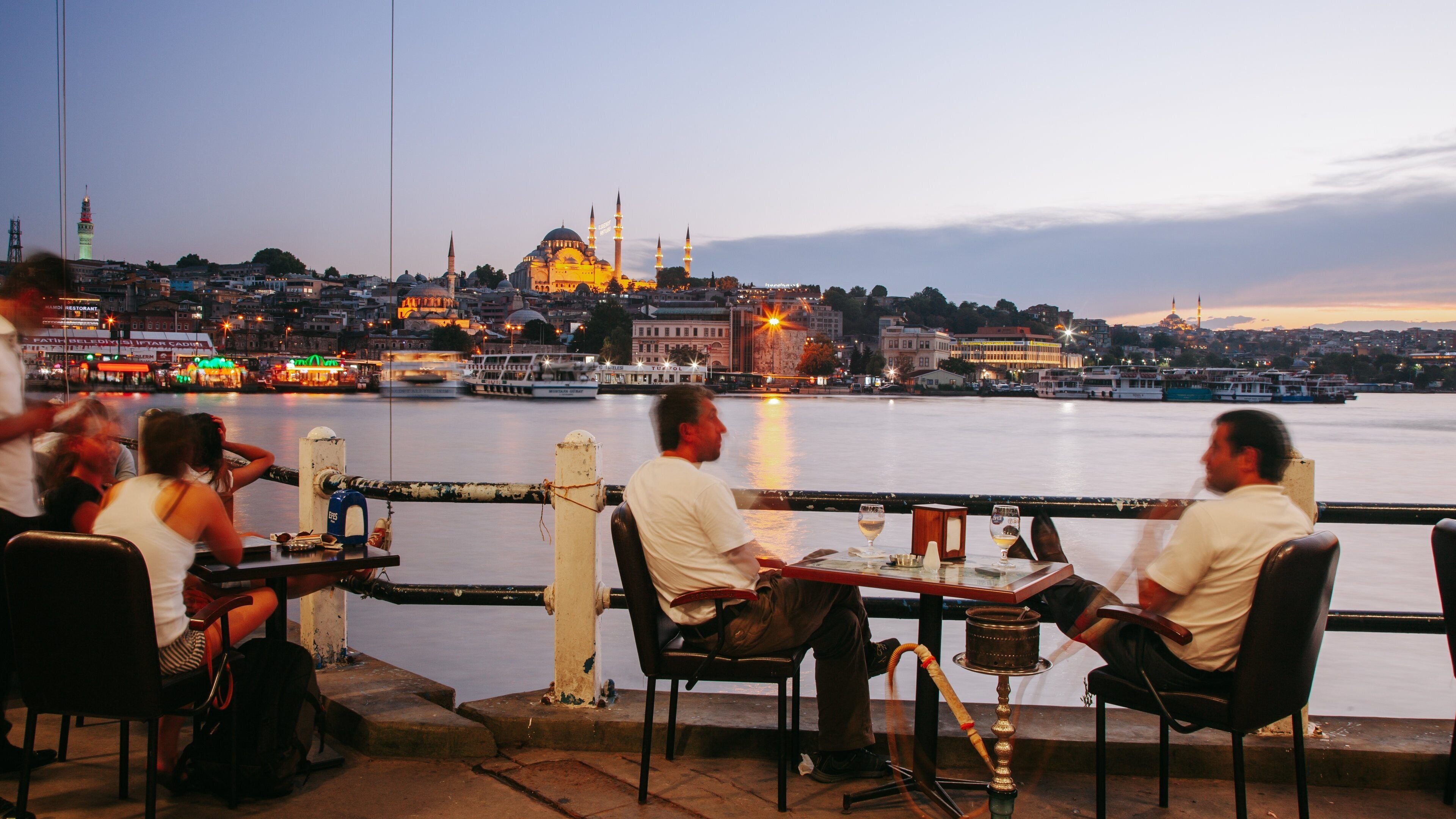 Galata Bridge which includes a sunset, dining out and outdoor eating