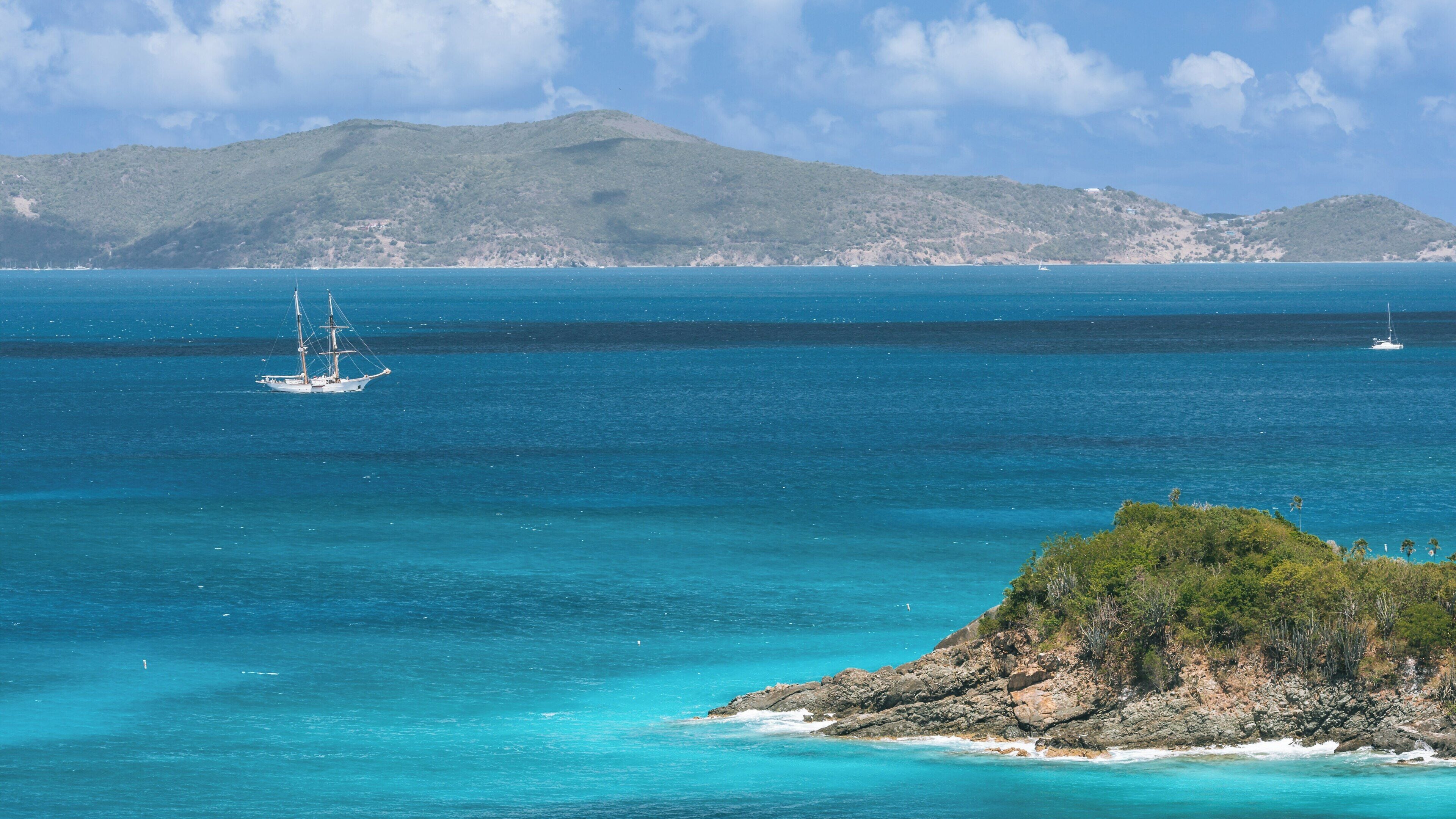 Trunk Bay showcases stunning turquoise waters and lush landscapes in St. John, U.S. Virgin Islands with sailboats enjoying the serene atmosphere