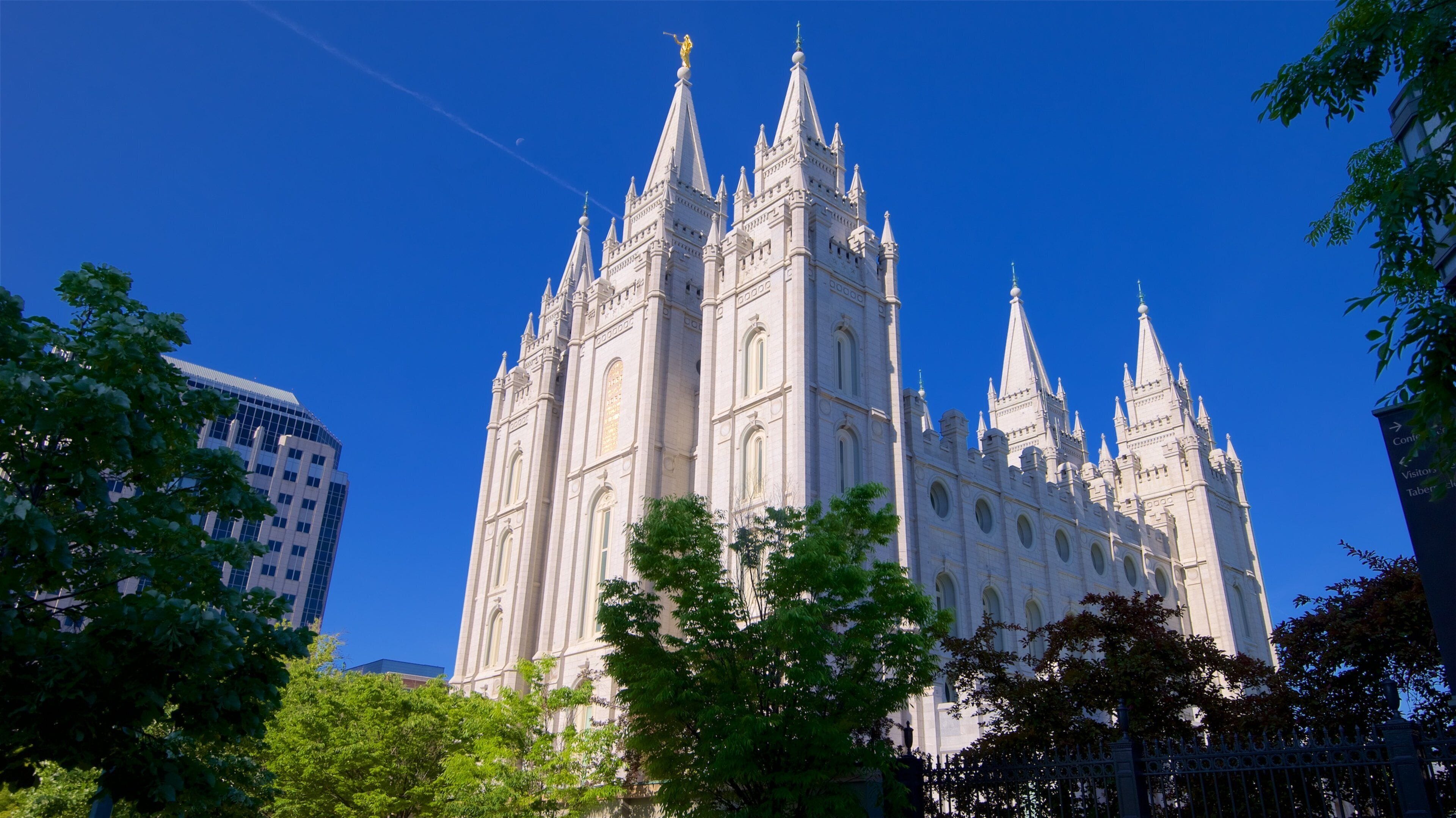 A large cathedral with multiple spires and a modern building nearby.