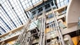 A modern building with a glass ceiling and metal framework.