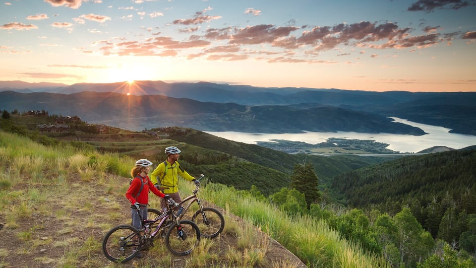Deer Valley Resort showing landscape views and a sunset as well as a small group of people
