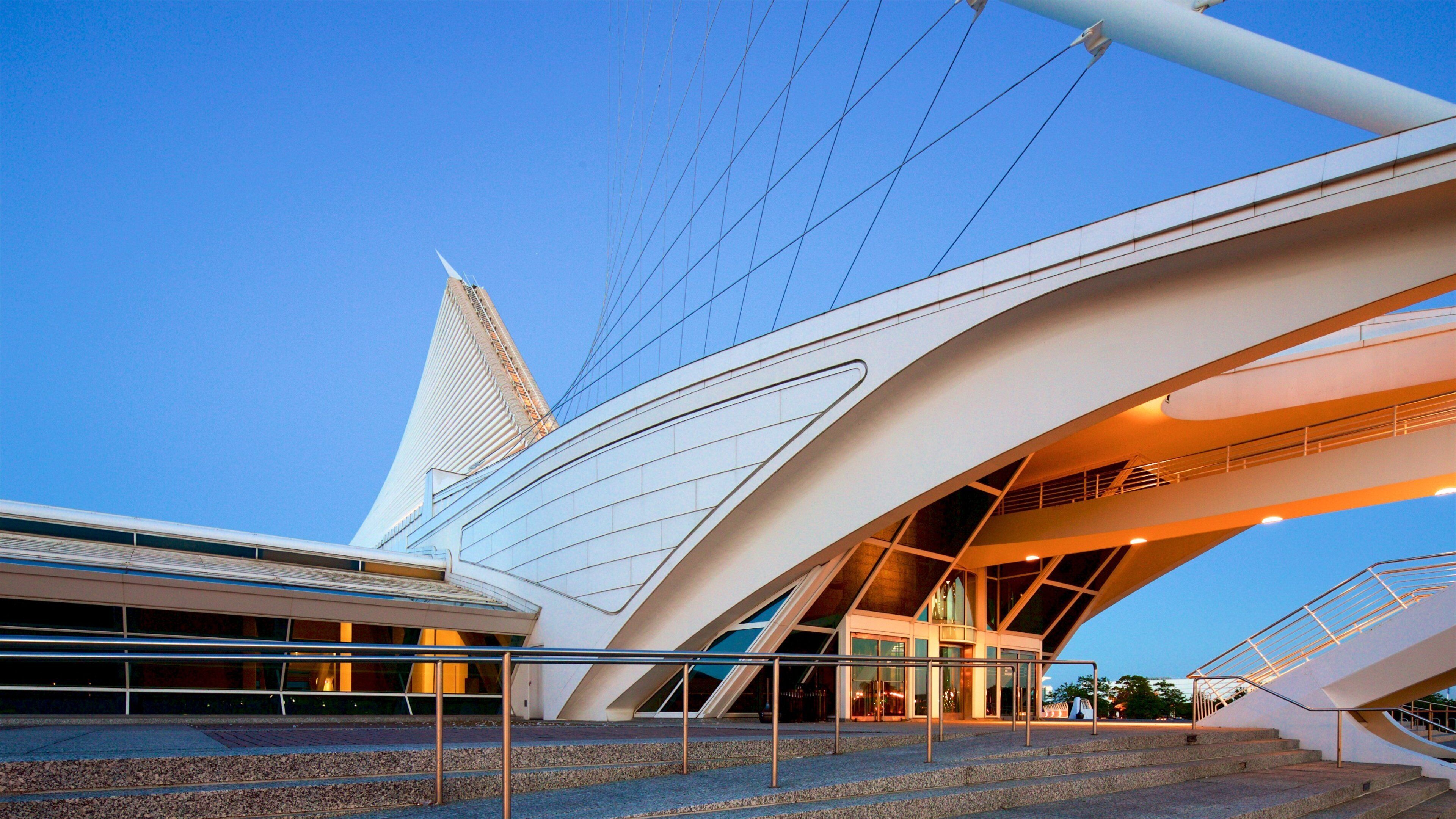 A modern architectural building with a unique design, featuring a prominent tower and curved structures.