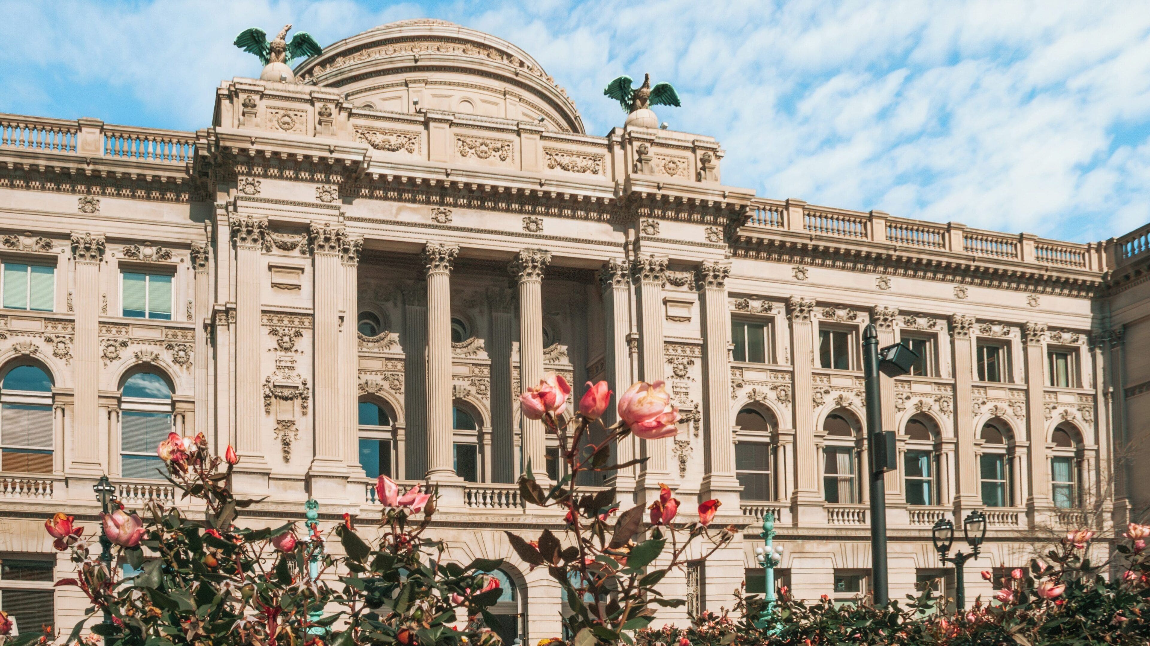 Milwaukee Public Library showcases beautiful architecture and blossoming flowers in Westown, Milwaukee, Wisconsin during a sunny day