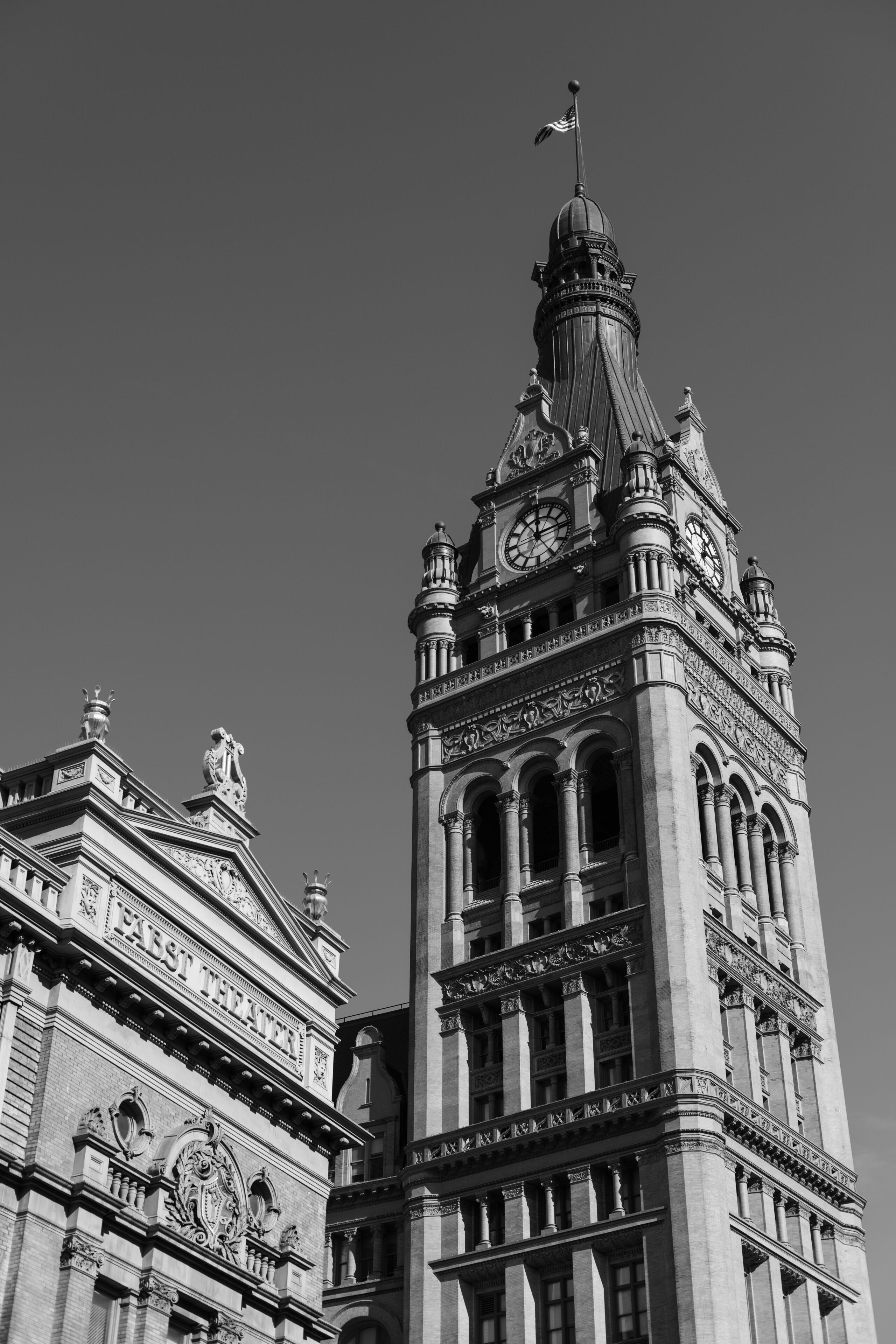 Grayscale of Milwaukee City Hall tower and adjacent Pabst Theater in Milwaukee, Wisconsin, USA