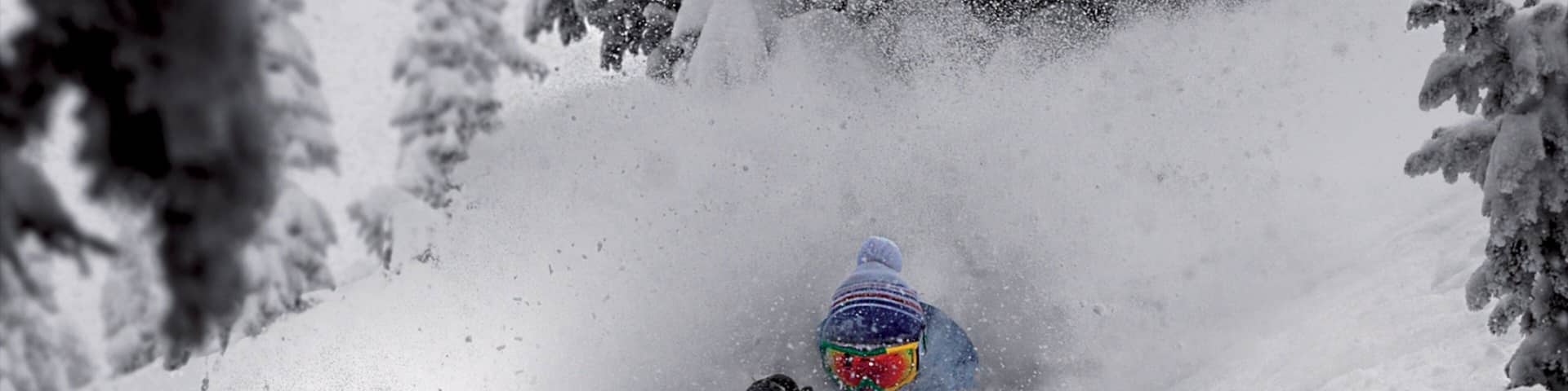 A person skiing down a snowy slope.