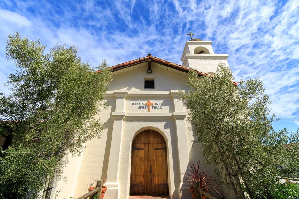 A church with a wooden door and a bell tower.