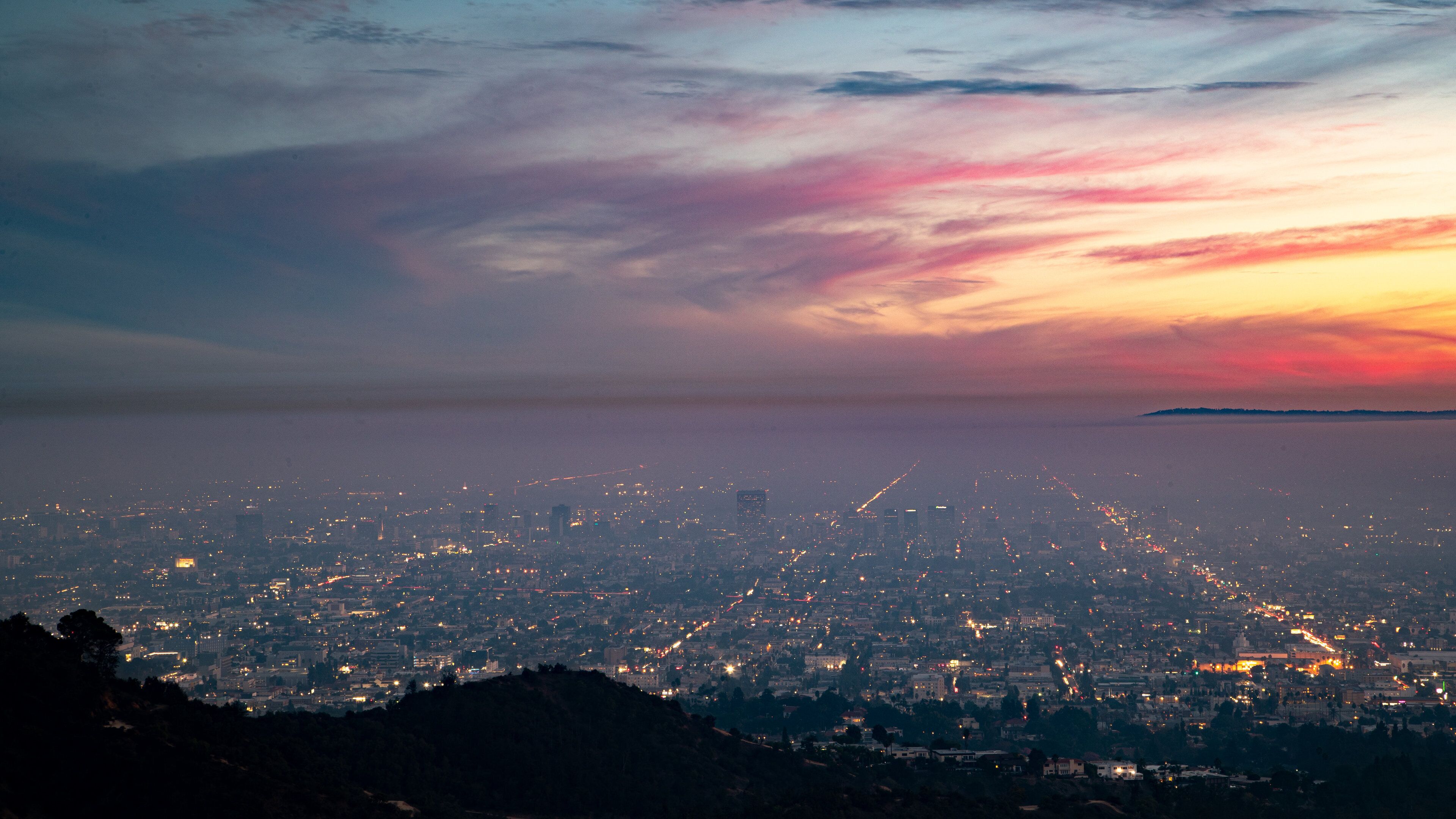 Griffith Observatory which includes a sunset, night scenes and a city