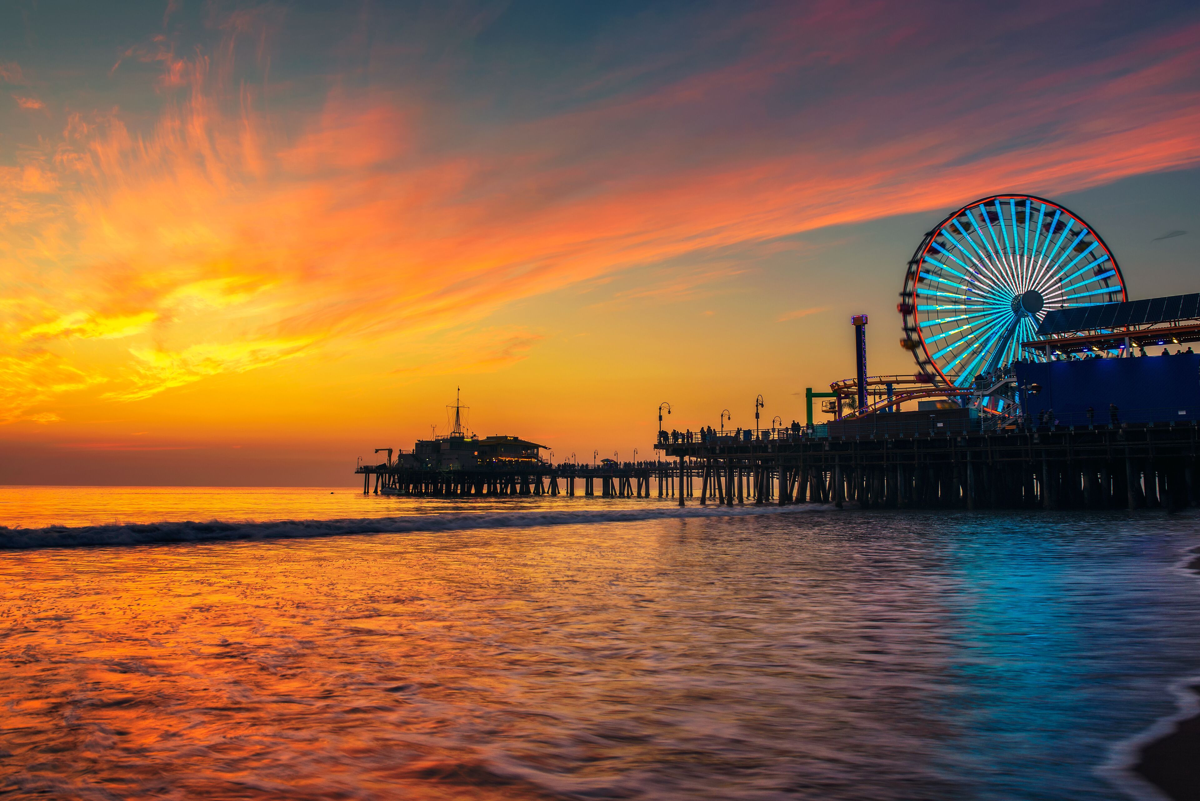 Visitors enjoy sunset above Santa Monica Pier in Los Angeles