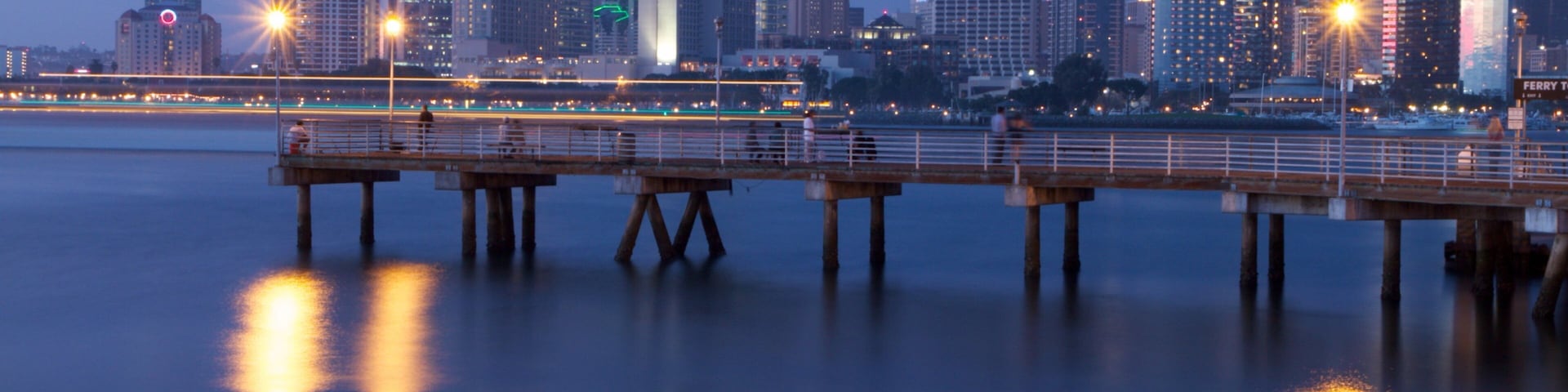 Coronado Beach which includes a bay or harbor, night scenes and a high rise building