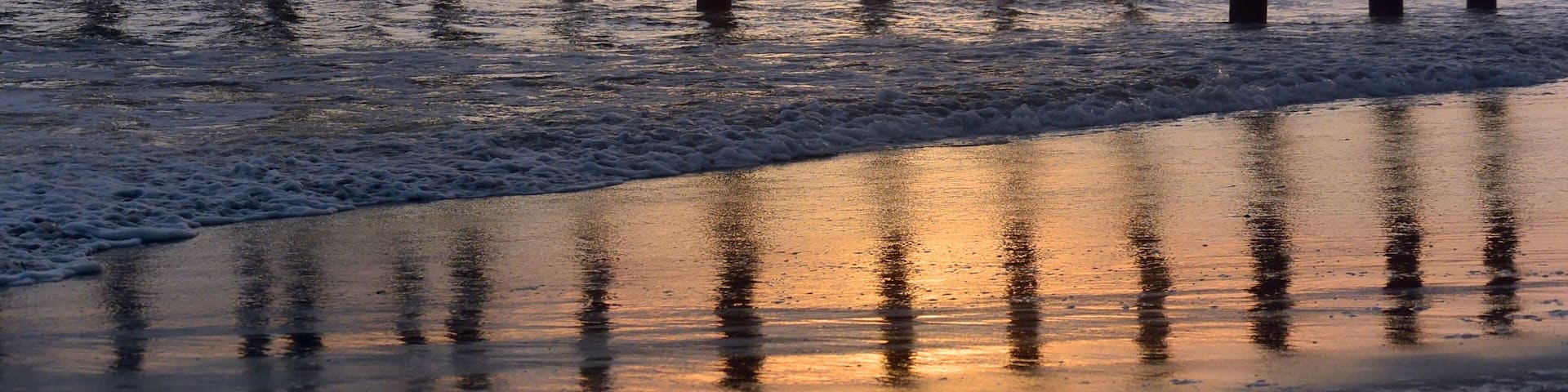Oceanside Pier reflection on the wet sand at sunset